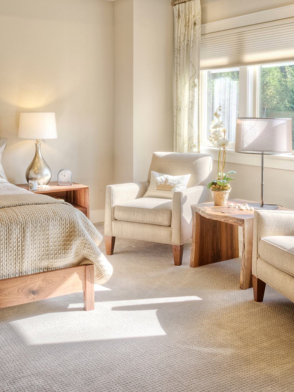 Sunny bedroom with freshly vacuumed carpet and armchairs