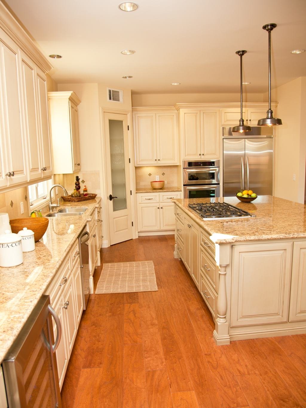 Cream kitchen with granite counters and wood floors