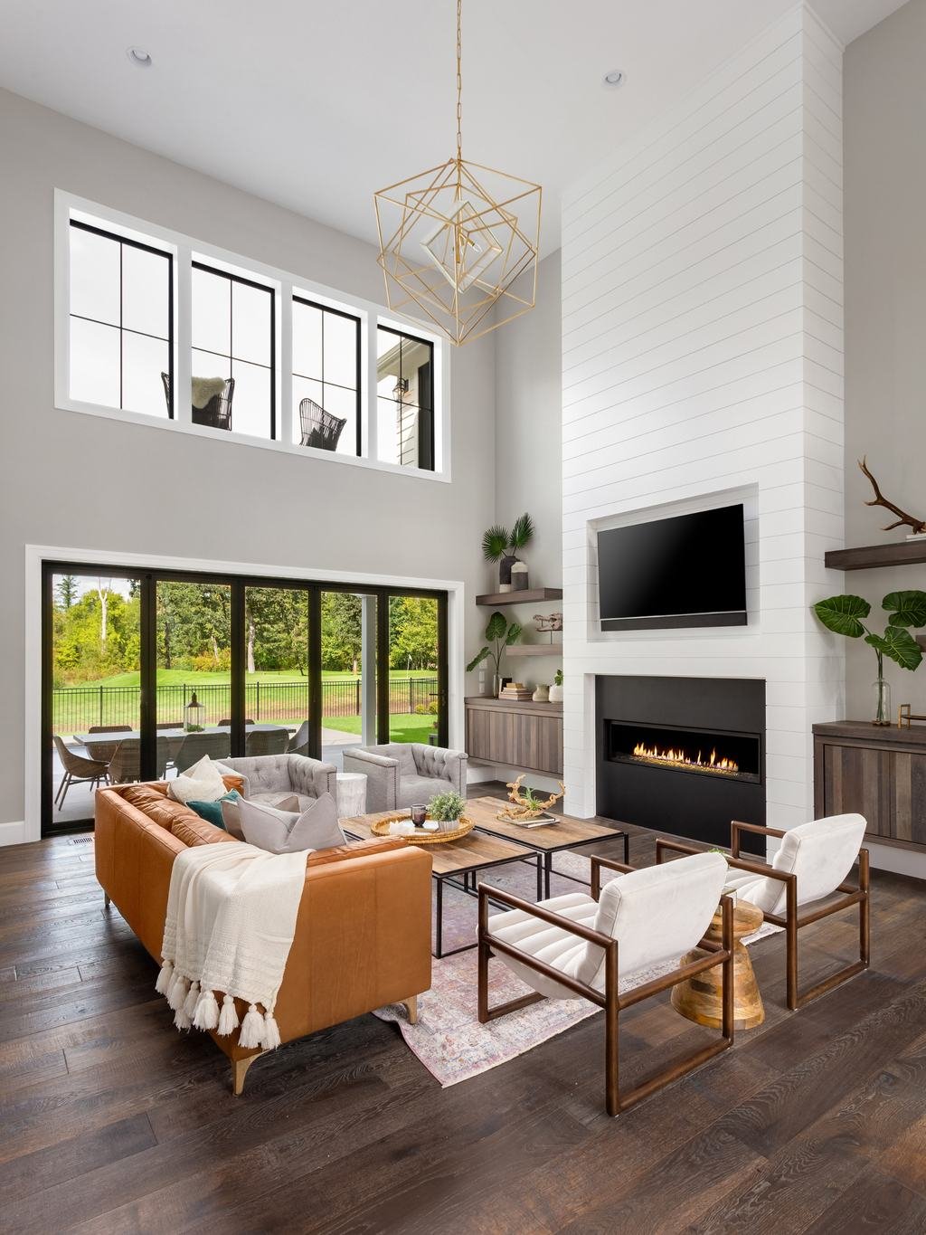 Bright, freshly cleaned living room with high ceilings and hardwood floors